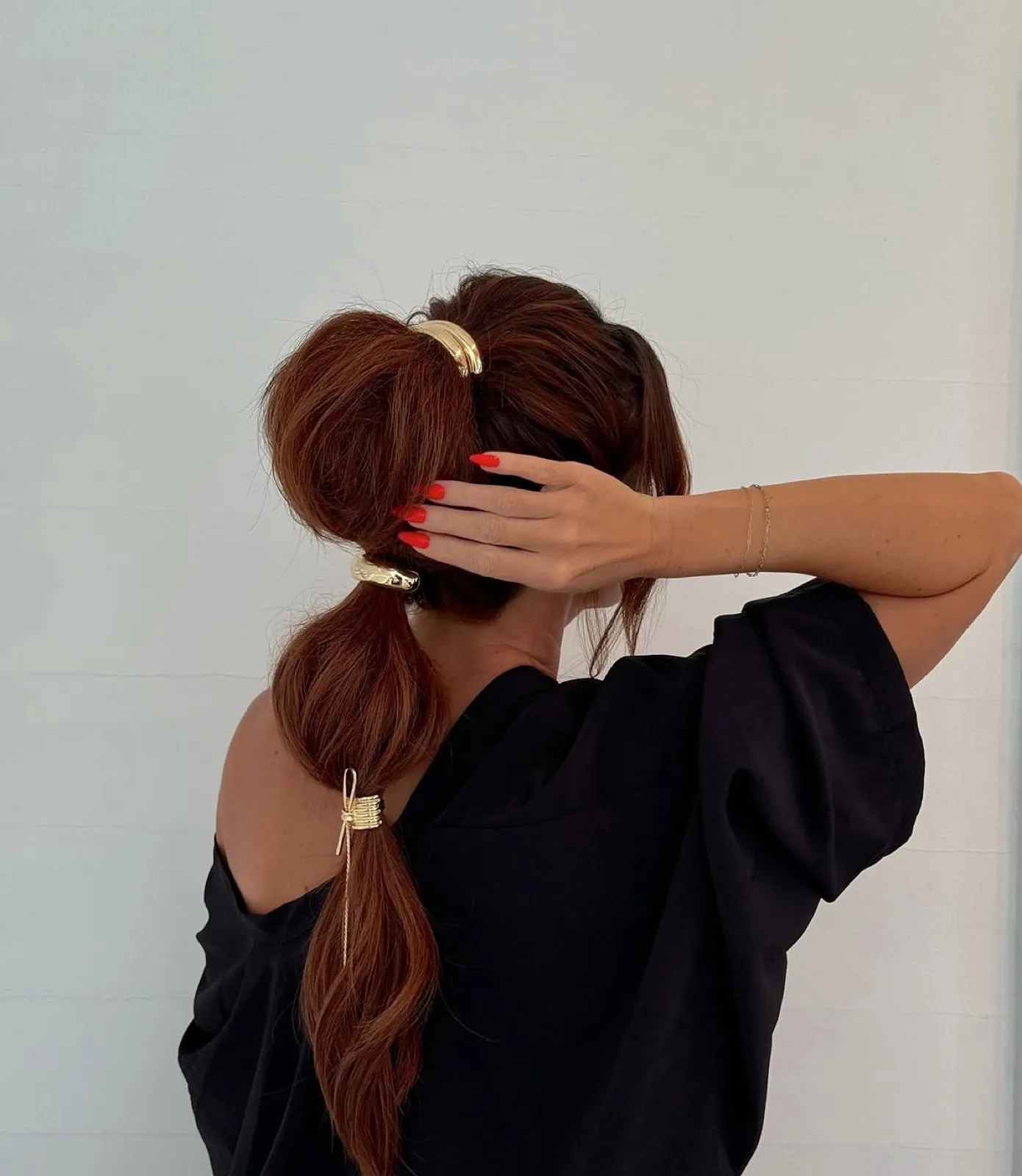 Auburn bubble ponytail with gold cuffs and chain detail