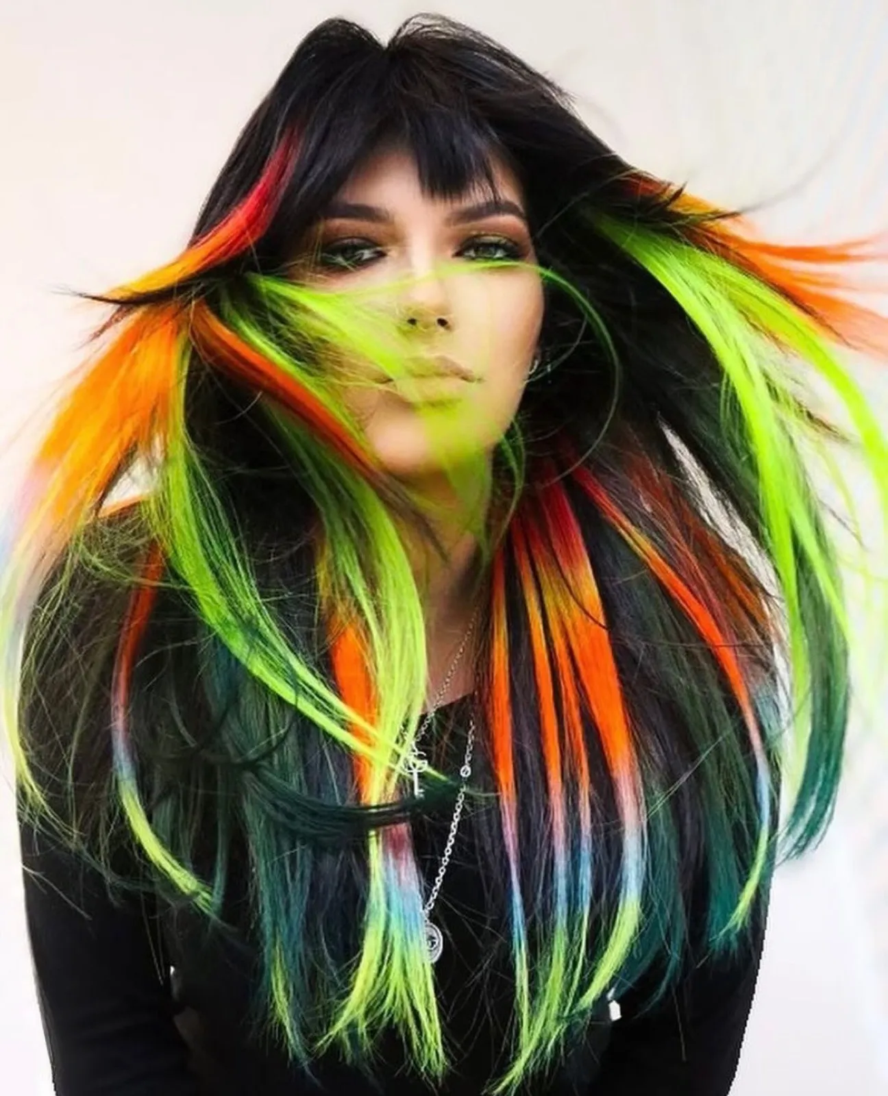 Creative vivid color with neon green and orange on black hair